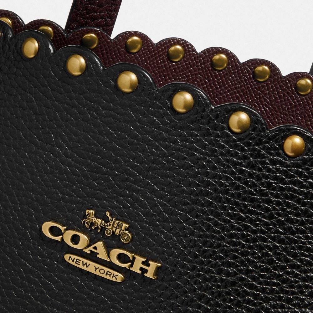 coach charlie carryall rivets