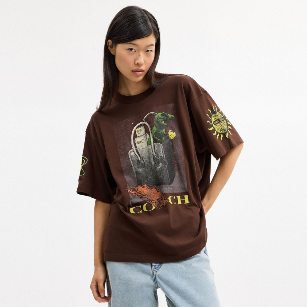 COACH®,Coach Graphic Relaxed T-Shirt In Organic Cotton,Organic Cotton,T Shirt,Logo,Casual,Brown,Scale View