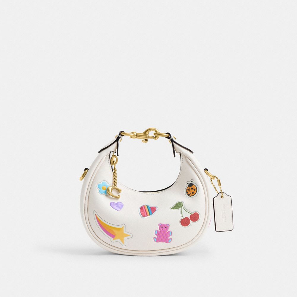 COACH®,Jonie Bag With Sticker Print,Leather,Fabric,Crossbody,Logo,Pendant,Circle,Embellished,Stitching,Piping,Pattern,Grap...,White,Front View