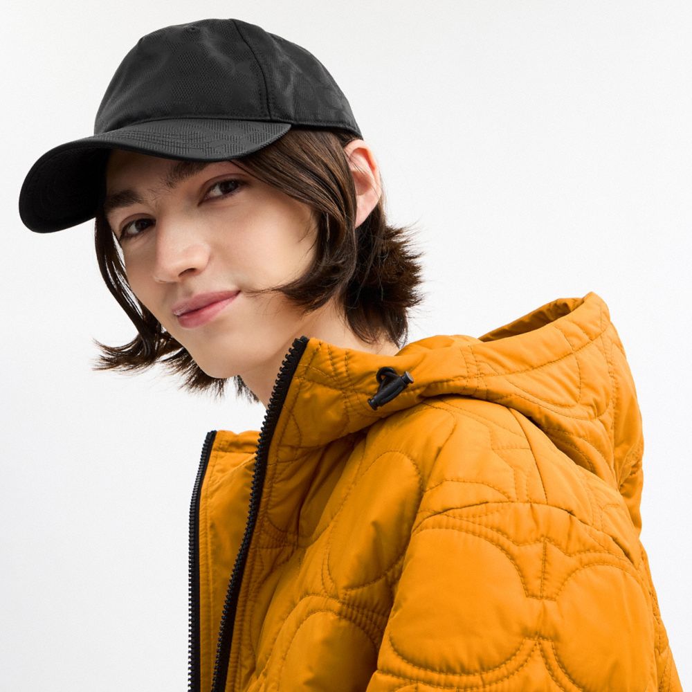 COACH®,Tonal Signature Baseball Hat,Nylon,Cotton,Baseball Cap,Metal,Graphic,Pattern,Grommet,Logo,Embossed,Cooling,Breathab...,Black,Angle View