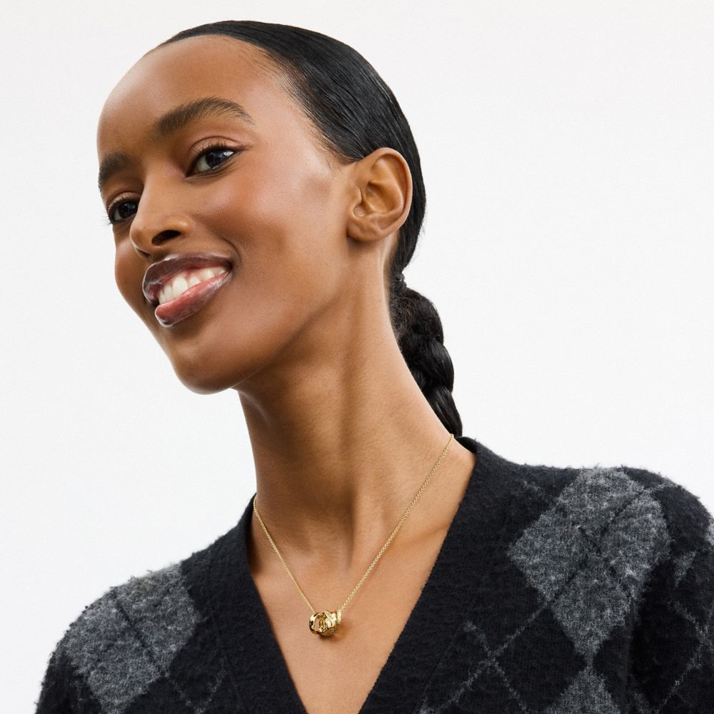 COACH®,Braided Signature Rondell Pendant Necklace,Single Strand,Glass,Cubic Zirconia,Logo,Gem Embellishment,Brass Gold,Casual,White,Detail View