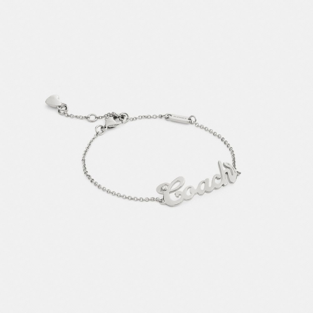 COACH®,Coach Script Nameplate Bracelet,Cubic Zirconia,Logo,Gem Embellishment,Bar Embellishment,Heart Embellishment,Letteri...,Clear,Front View