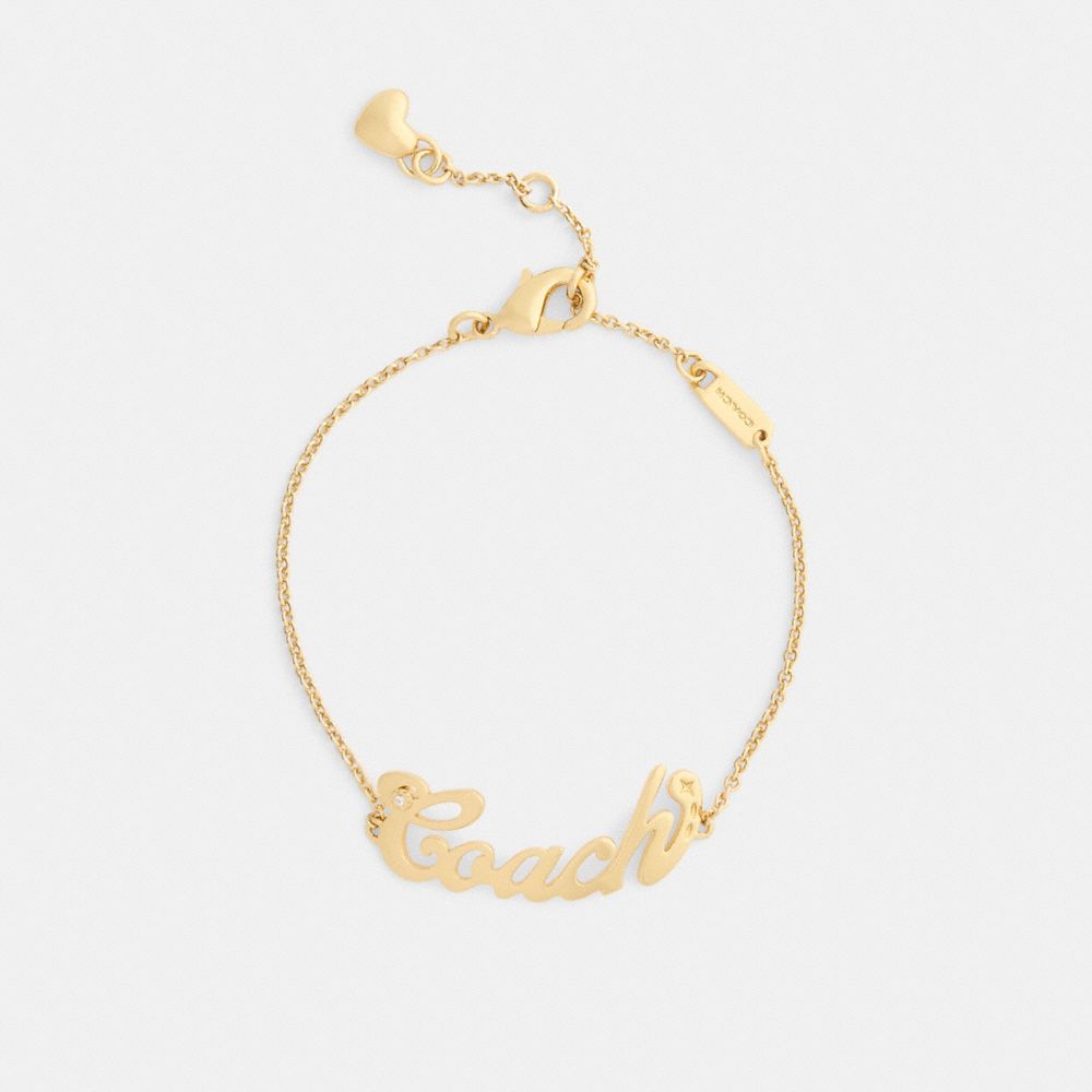 COACH®,Coach Script Nameplate Bracelet,Metal Material,Cubic Zirconia,Logo,Heart Embellishment,Gem Embellishment,Bar Embell...,Clear,Inside View,Top View