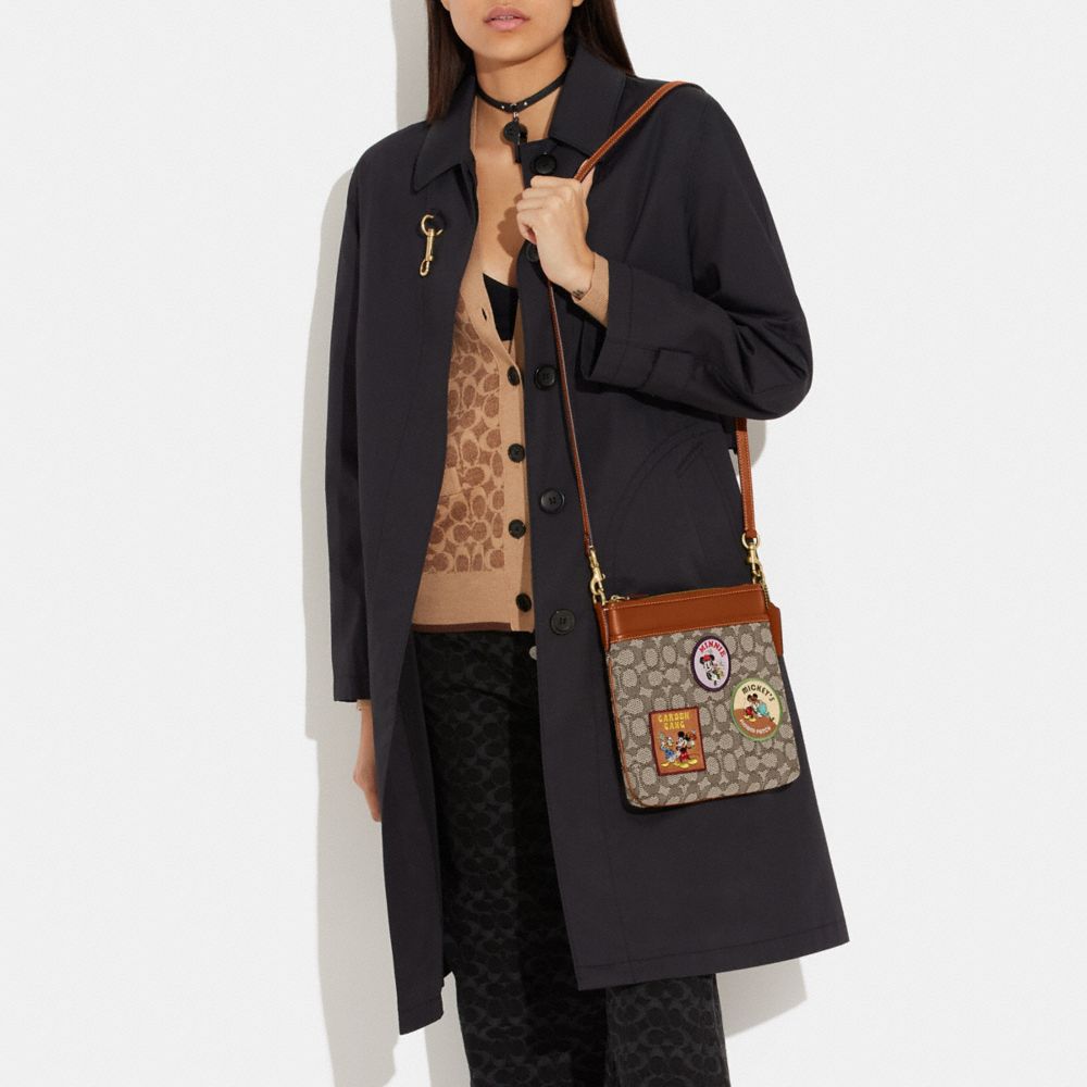 COACH®,DISNEY X COACH KITT MESSENGER CROSSBODY IN SIGNATURE TEXTILE JACQUARD WITH PATCHES,Jacquard,Medium,,Detail View