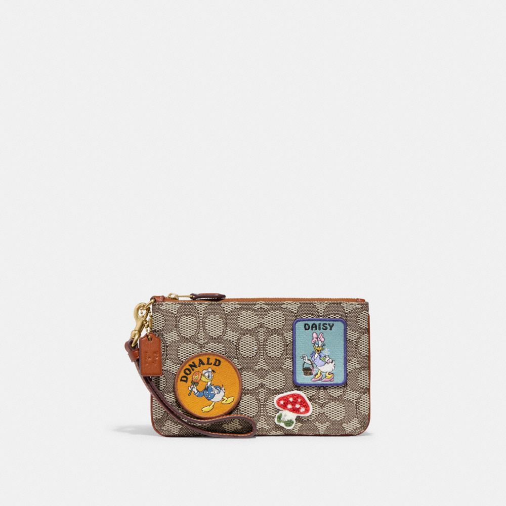 COACH®,DISNEY X COACH SMALL WRISTLET IN SIGNATURE TEXTILE JACQUARD WITH PATCHES,Signature Jacquard,Mini,,Front View