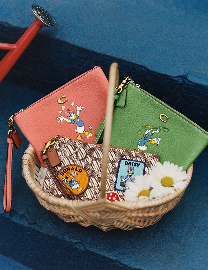 COACH®,DISNEY X COACH SMALL WRISTLET IN SIGNATURE TEXTILE JACQUARD WITH PATCHES,Signature Jacquard,Mini,,Detail View